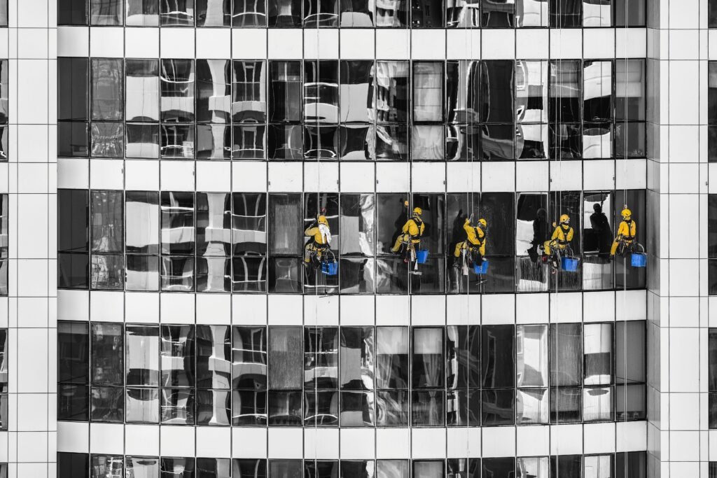 High-rise window cleaners in Dubai cleaning a skyscraper, showcasing urban architecture.